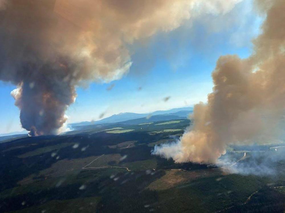 - BC Wildfire Service/AFP via Gett
This file handout photo courtesy of BC Wildfire Service shows two plumes of smoke from the Long Loch wildfire and the Derrickson Lake wildfire on June 30.