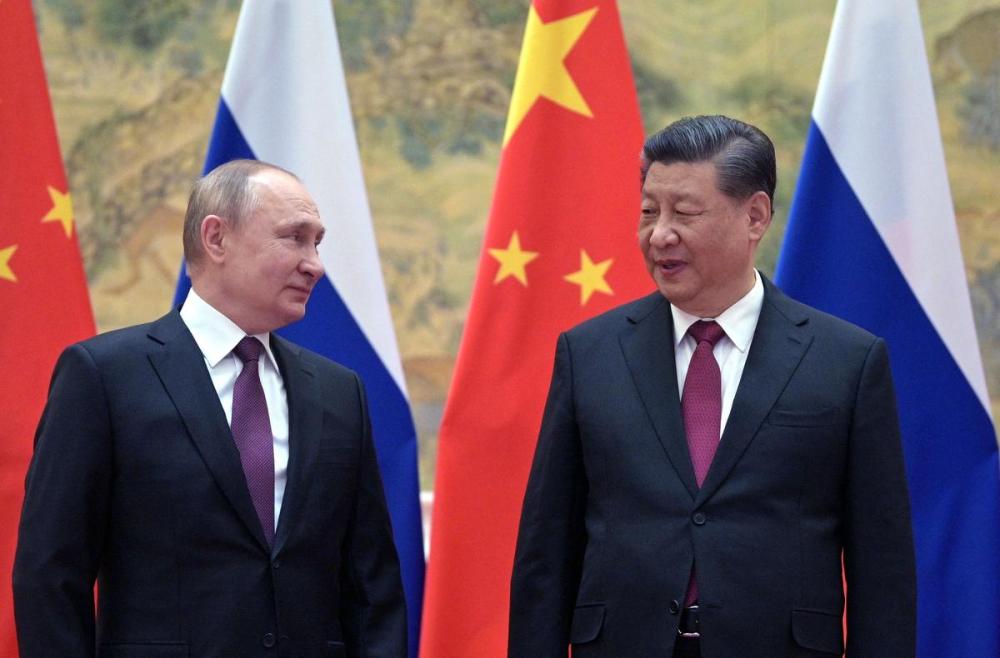 ALEXEI DRUZHININ - Sputnik/AFP via GETTY IMAGES
Russian President Vladimir Putin, left, and Chinese President Xi Jinping, right, pose for a photograph in Beijing on Feb. 4, 2022.