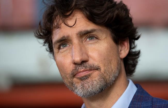 Prime Minister Justin Trudeau listens to a question as he speaks with media following an announcement in Brockville, Ont., Friday, Aug. 21, 2020. THE CANADIAN PRESS/Adrian Wyld