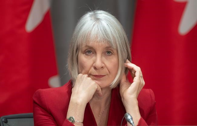 Minister of Health Patty Hajdu listens to a translation aid during a news conference in Ottawa, Wednesday, April 1, 2020. THE CANADIAN PRESS/Adrian Wyld