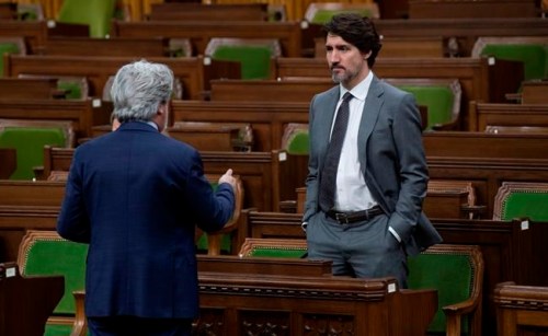 Prime Minister Justin Trudeau speaks with Leader of the Government in the House of Commons Pablo Rodriguez as they wait for the COVID-19 committee in the House of Commons Chamber Wednesday April 29, 2020 in Ottawa. THE CANADIAN PRESS/Adrian Wyld