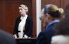 JIM LO SCALZO - POOL/AFP VIA GETTY IMAGES
Amber Heard testifies as her ex-husband Johnny Depp looks on. Based on social media, especially TikTok posts, Depp is clearly “winning” his defamation case, says Vinay Menon.