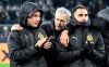 Dortmund's head coach Lucien Favre, center, talks to substitute players Mario Goetze, left, and Paco Alcacer, right, after winning the Champions League Group F soccer match between Borussia Dortmund and Slavia Praha in Dortmund, Germany, Tuesday, Dec. 10, 2019. Borussia defeated Slavia with 2-1. (AP Photo/Martin Meissner)