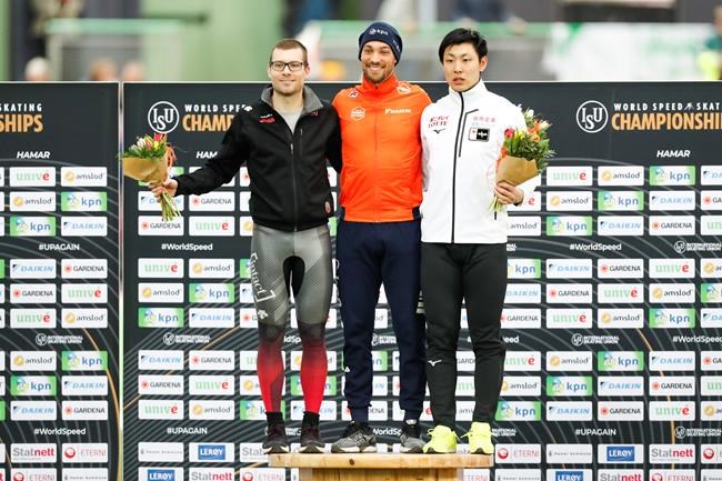Winners gather on the podium after the 1000m men event with winner Kjeld Nuis from the Netherlands, second placed Laurent Dubreuil from Canada, left, and third placed Tatsuya Shinhama from Japan, right, during the World Cup skating all-round 2020 in the Viking ship at Hamar in Norway, Saturday Feb. 29, 2020. Tatsuya Shinhama at right, was also crowned World Champion overall sprint. (Geir Olsen / NTB scanpix via AP)
