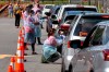 A man wearing a facemask waits inside his car to be tested for COVID-19 as volunteers take registration information in Annandale, Va., Saturday, May 23, 2020. COVID-19 testing was available from Fairfax County at no cost and without a doctor's order. Hundreds of people had lined up in cars and on foot by 10am. Officials planned on testing about 1000 people from 10 a.m. to 6 p.m. Testing will be available at Bailey's Elementary on Sunday. (AP Photo/Jacquelyn Martin)