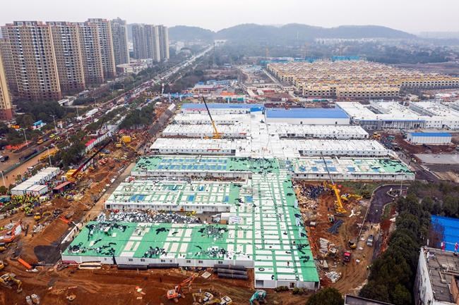 The Huoshenshan temporary field hospital under construction is seen as it nears completion in Wuhan in central China's Hubei Province, Sunday, Feb. 2, 2020. The Philippines on Sunday reported the first death from a new virus outside of China, where authorities delayed the opening of schools in the worst-hit province and tightened quarantine measures in a city that allow only one family member to venture out to buy supplies. (Chinatopix via AP)
