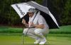 Lynne Sladky - The Associated Press
Daniel Berger tries to stay dry as he waits to putt on the 10th hole during first-round play at the weather-challenged Players Championship on Friday. He was at 5 under when play was called.