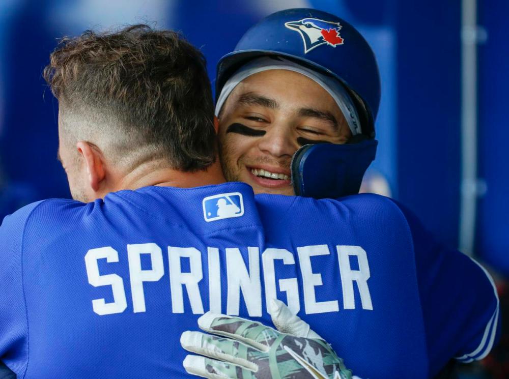 Rick Madonik - Toronto Star
After his second long ball of the game, Blue Jay Bo Bichette gets some love from teammate George Springer in the dugout Saturday.