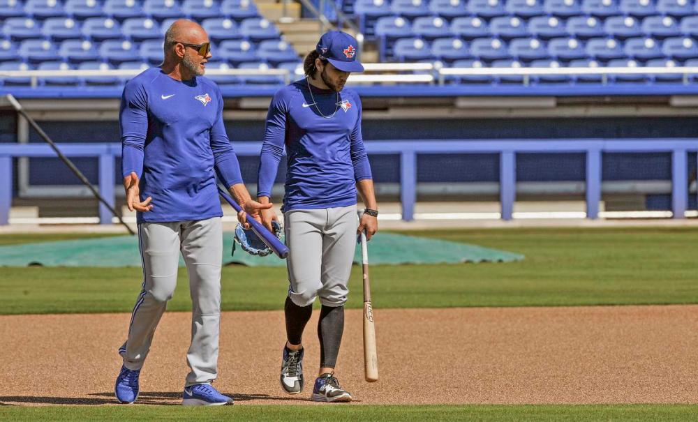 Steve Nesius - THE CANADIAN PRESS
Dante Bichette, left, consulting with his son, Blue Jays shortstop Bo Bichette, during 2020 spring training, is back with the team for September as the Jays try to wake their offence.
