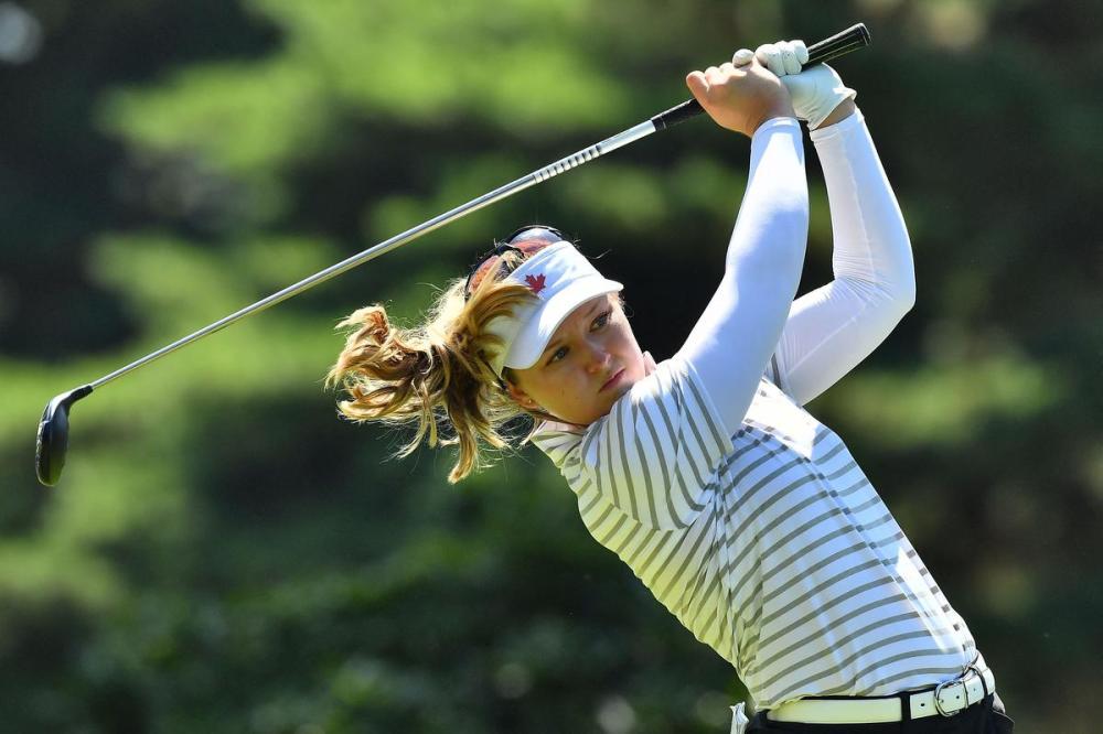 KAZUHIRO NOGI - AFP via GETTY IMAGES
Canada's Brooke Henderson watches her drive from the 14th tee in Round 2 of the women’s golf individual stroke play during the Tokyo Olympics on Thursday.