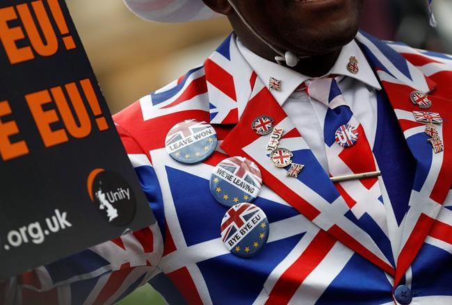 A Brexit supporter demonstrates in Parliament Square in London, Friday, Jan. 31, 2020. Britain officially leaves the European Union on Friday after a debilitating political period that has bitterly divided the nation since the 2016 Brexit referendum. (AP Photo/Alastair Grant)