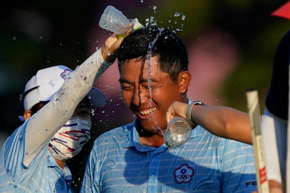 Matt York - AP
C.T. Pan, of Chinese Taipei, is doused with water after wining the bronze medal at the men's golf event at the 2020 Tokyo Olympics on Sunday.