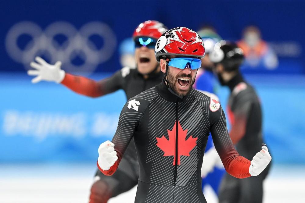 David Ramos - GETTY IMAGES
Canada’s Charles Hamelin celebrates after winning the gold medal with his teammates in the men's 5,000-metre relay at the Winter Olympics in Beijing.