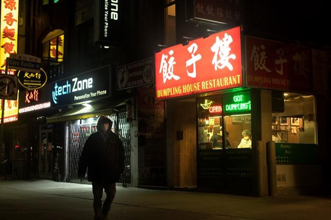 A restaurant worker is seen in the window of an eatery in Toronto on Saturday, May 9, 2020. THE CANADIAN PRESS/Chris Young