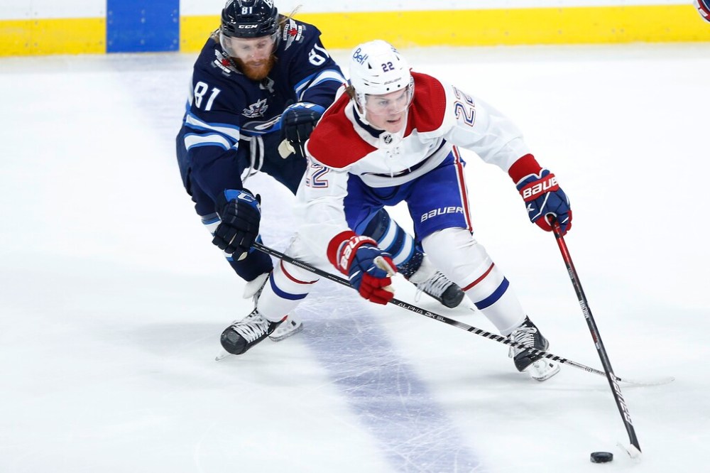 CP
Kyle Connor chases Cole Caufield during the second period Friday. Connor got neither puck nor body on the play where Montreal scored a short-handled goal. (John Woods / The Canadian Press)