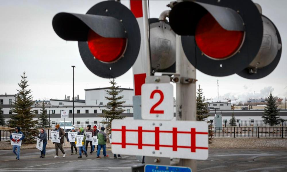 Jeff McIntosh - THE CANADIAN PRESS
Locked-out workers picket the Canadian Pacific Railway headquarters in Calgary, Alta., on March 20.