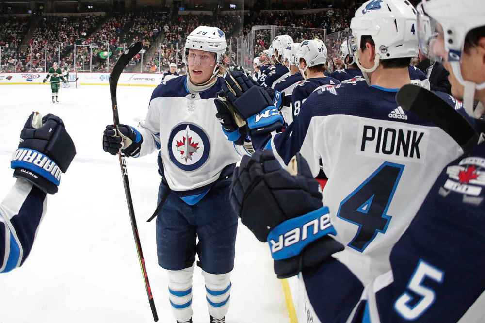 Winnipeg Jets right wing Patrik Laine is congratulated by teammates after scoring a goal on the Minnesota Wild. (Andy Clayton-King / The Associated Press)