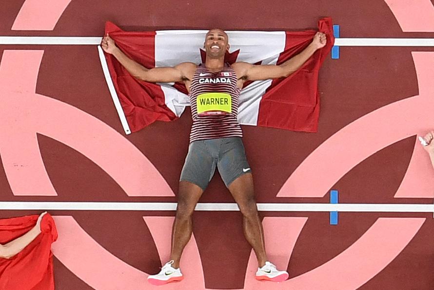 ANTONIN THUILLIER - AFP via Getty Images
Damian Warner set Canadian and Olympic records while winning gold in the decathlon last week. It’s a good thing he had that flag; he will need it in the closing ceremony.