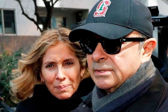 FILE - This March, 2019, file photo shows former Nissan Chairman Carlos Ghosn, right, and his wife Carole in Tokyo. Tokyo prosecutors issued an arrest warrant Tuesday, Jan. 7, 2020 for the wife of Nissan's former chairman, Carlos Ghosn, on suspicion of perjury. (Kyodo News via AP, File)