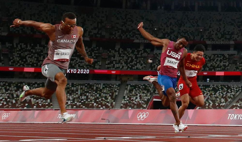 Rick Madonik - Toronto Star
Canadian bronze medallist Andre de Grasse, left, said after that he was so focused on the finish line that he didn’t notice the runner in Lane 7 had pulled up.