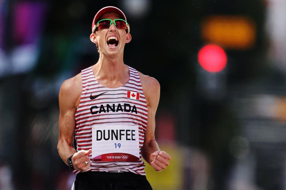 Clive Brunskill - GETTY IMAGES
Canada’s Evan Dunfee celebrates after crossing the finish line in third in the men's 50-kilometre race walk.