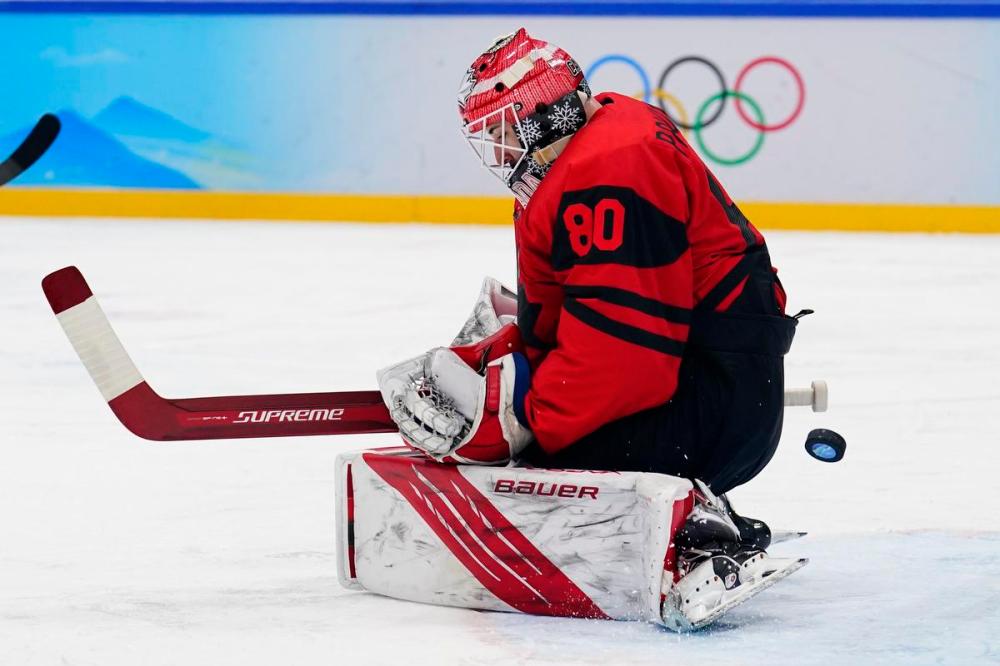 Matt Slocum - AP
A shot by United States' Kenny Agostino gets past Canada goalie Eddie Pasquale for a back-breaking goal during a preliminary round men's hockey game at the 2022 Winter Olympics on Saturday in Beijing.