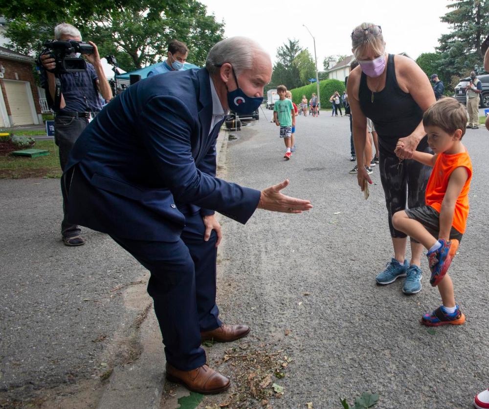 Ryan Remiorz - THE CANADIAN PRESS
Conservative Leader Erin O’Toole greets some neighbourhood children after making an announcement on affordable housing in Ottawa on Aug. 19, 2021.