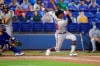 Atlanta Braves Cristian Pache follows through on a grand slam home run in front of Toronto Blue Jays catcher Alejandro Kirk during the second inning of a baseball game Saturday, May 1, 2021, in Dunedin, Fla. (AP Photo/Mike Carlson)