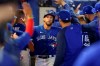 Toronto Blue Jays' George Springer is congratulated after his two-run home run against the Atlanta Braves during the third inning of a baseball game Saturday, May 1, 2021, in Dunedin, Fla. (AP Photo/Mike Carlson)