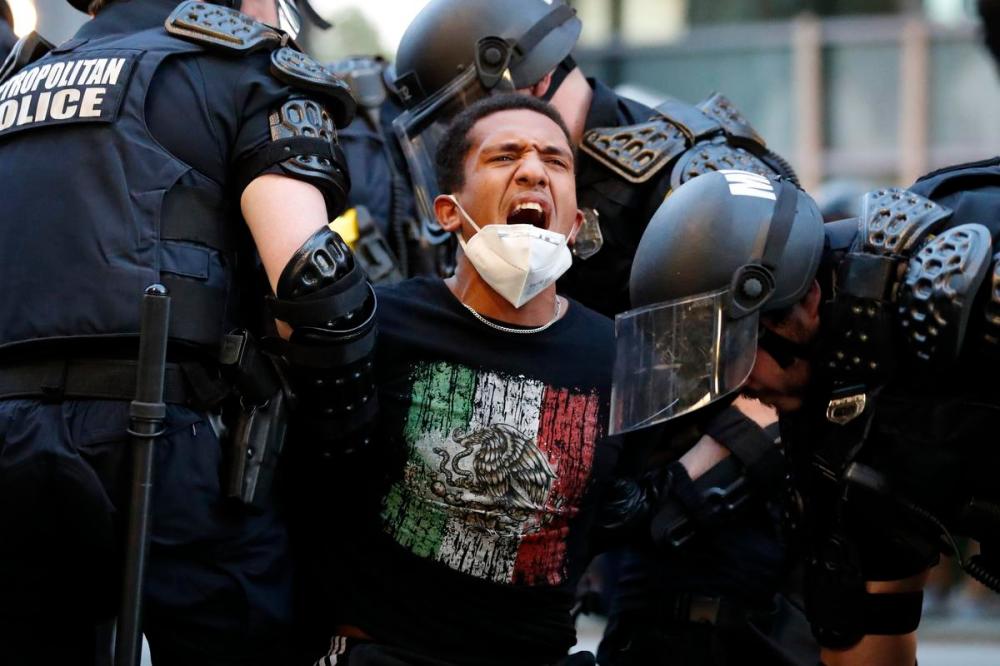 Alex Brandon - AP FILE PHOTO
A demonstrator is taken into custody by police after a curfew took effect during a protest over the death of George Floyd on June 1, 2020, near the White House in Washington.
