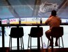 A patron watches TV in a bar prior to NHL exhibition action against the Columbus Blue Jackets in Toronto on Thursday, July 30, 2020. As summer heat shimmers off the pavement and parked cars become stultifying ovens, Canada’s favourite winter pastime is officially back. The question is whether fans, finally able to enjoy the outdoors in this COVID year of masks and misery, will tune in to watch NHL playoff hockey beamed in from empty hub-bubble arenas. THE CANADIAN PRESS/Frank Gunn