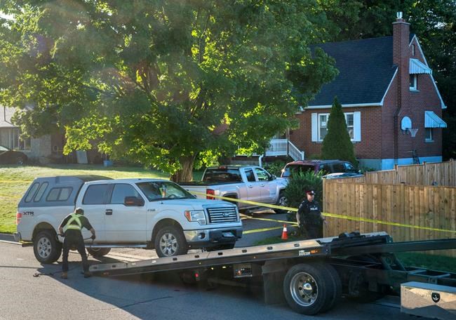Police remove a truck with Manitoba licence plates from the front of a home on Parklane Avenue in Oshawa, Ont. on Friday, September 4, 2020. Durham Regional Police say five people were found dead and another with serious injuries in the home east of Toronto after an early morning shooting. THE CANADIAN PRESS/Frank Gunn