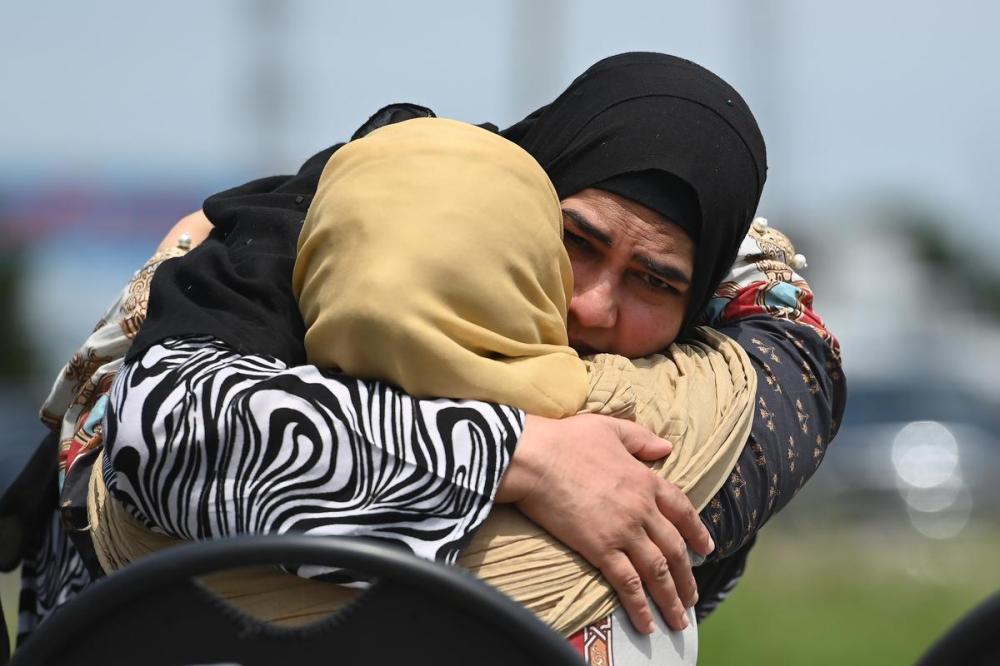Nathan Denette - THE CANADIAN PRESS
Family members comfort each other during the funeral service for the four Muslim family members killed in a deadly vehicle attack, at the Islamic Centre of Southwest Ontario in London, Ont., on Saturday.