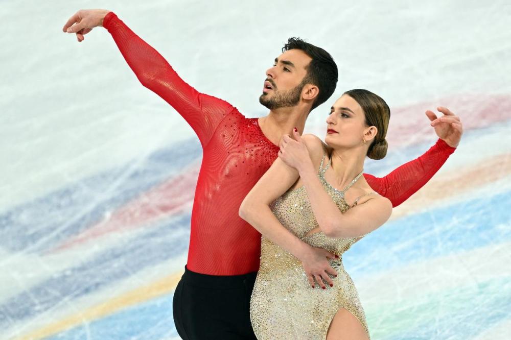 SEBASTIEN BOZON - AFP via GETTY IMAGES
France's Gabriella Papadakis and France's Guillaume Cizeron won gold in the ice dance competition Monday during the Beijing 2022 Winter Olympic Games at the Capital Indoor Stadium in Beijing.