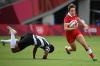 GREG BAKER - AFP via GETTY IMAGES
Canada's Ghislaine Landry (right) runs past Fiji's Rusila Nagasau to score a try in the women's pool B rugby sevens match between Canada and Fiji at the Tokyo Olympics on Thursday.