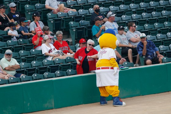 JOHN WOODS / WINNIPEG FREE PRESSGoldie elbow bumps with fans at the Goldeyes game at Shaw Park on Tuesday, the team's first game at home since 2019.