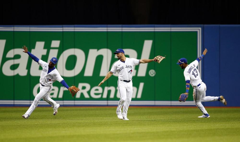 Vaughn Ridley - GETTY IMAGES
From left, Jays outfielders Teoscar Hernandez, Randal Grichuk and Lourdes Gurriel Jr. celebrate an improbable comeback win Friday night over the Oakland Athletics at Rogers Centre.