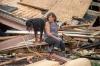 Scott Clause - AP
Fran Tribe and her dog Dave sit outside a home destroyed by Hurricane Ida in Houma, La. on Aug. 30, 2021.