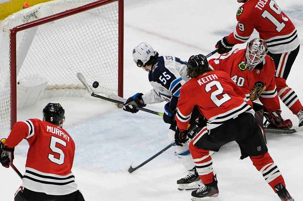 Winnipeg Jets center Mark Scheifele (55) scores a goal on Chicago Blackhawks goaltender Robin Lehner (40) during the second period. (David Banks / The Associated Press)