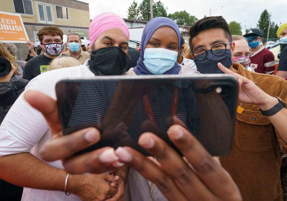 Paul Chiasson - THE CANADIAN PRESS
Local candidate Blake Desjarlais, right, takes a souvenir photo of NDP Leader Jagmeet Singh and a supporter during a campaign rally in Edmonton on Aug. 19, 2021.