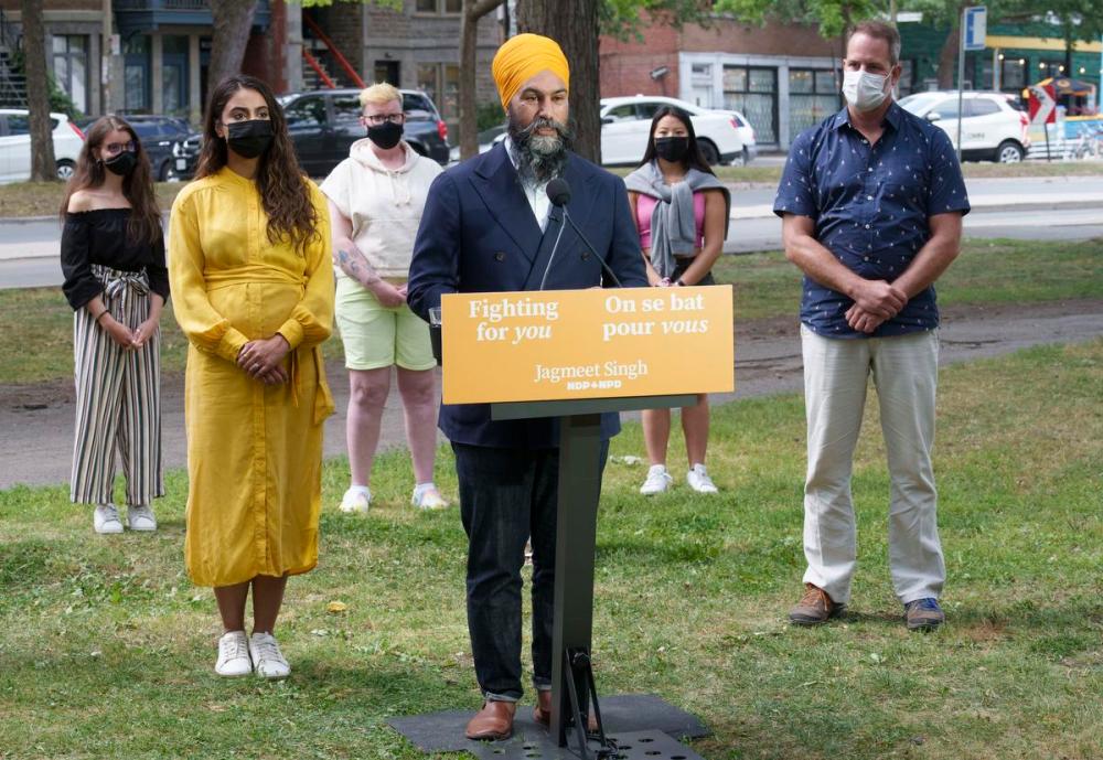 Paul Chiasson - THE CANADIAN PRESS
NDP Leader Jagmeet Singh responds to questions surrounded by his wife Gurkiran Kaur Sidhu, local MP Alexandre Boulerice, right, and supporters during a news conference in a park in Montreal on Aug. 15, 2021.