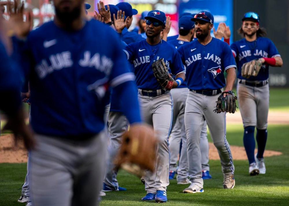 Stephen Maturen - Getty Images
The Blue Jays celebrated a victory and a series split against the Twins on Sunday.