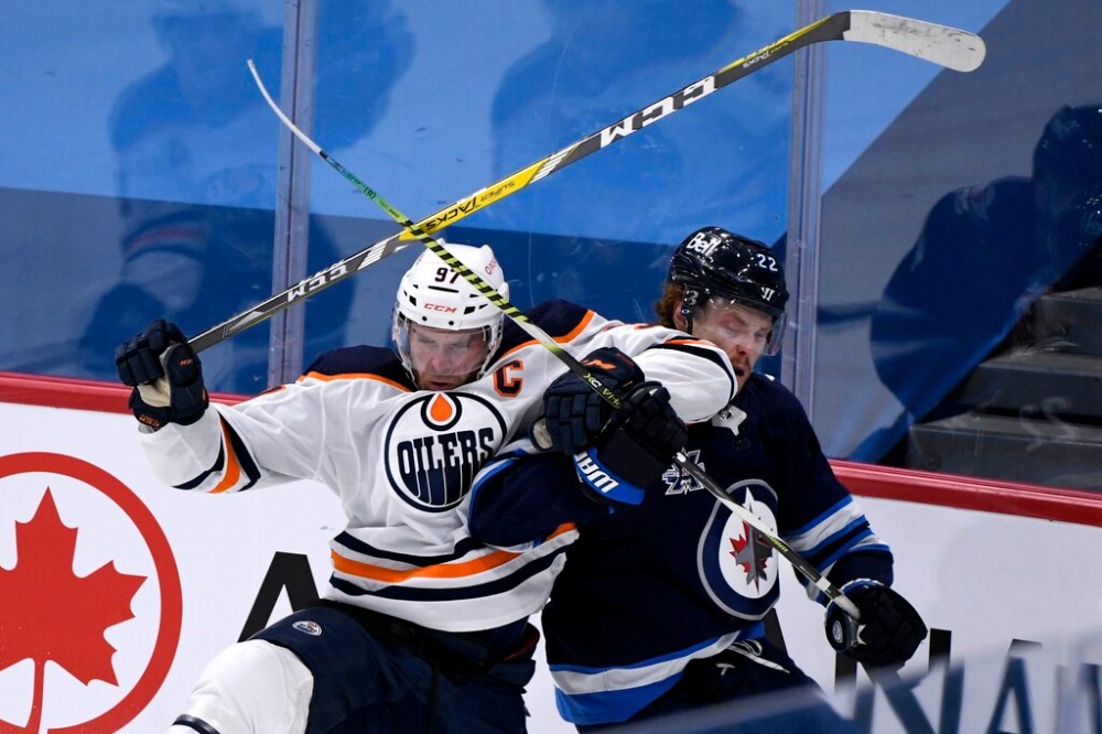 THE CANADIAN PRESS/Fred Greenslade
Winnipeg Jets' Mason Appleton collides with Edmonton Oilers' Connor McDavid during the first period Tuesday.