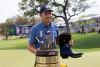 Michael Thomas - AP
Jordan Spieth stands with the Valero Texas Open trophy and the boots awarded to the champion of the Valero Texas Open golf tournament in San Antonio on Sunday.