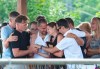 Amelie Lemieux, centre, is comforted by family members as she holds pictures of her two daughters, Romy and Norah Carpentier, at a memorial in Levis, Que. on Monday, July 13, 2020. The bodies of Norah and Romy Carpentier, aged 11 and 6, were located in a wooded area in St-Apollinaire, Que., but Martin Carpentier, who is suspected of abducting the girls, remains missing. THE CANADIAN PRESS/Jacques Boissinot