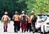 Police officers and volunteers march to the woods to search, Friday, July 10, 2020 in Saint-Apollinaire Que. Quebec provincial police continue to search for the father of two young girls found dead last weekend in a rural area southwest of Quebec City. THE CANADIAN PRESS/Jacques Boissinot