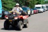 A police officer drives his quad on a street, Friday, July 10, 2020 in Saint-Apollinaire, Que. Police are continuing their search around a Quebec City suburb after they issued an Amber Alert Thursday for two young girls and their 44-year-old father who investigators believe disappeared following a highway car crash. THE CANADIAN PRESS/Jacques Boissinot