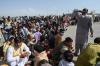 AFP Contributor#AFP - AFP via GETTY IMAGES
People wait to leave the Kabul airport on Monday after a stunningly swift end to Afghanistan's 20-year war, with thousands trying to flee the Taliban.