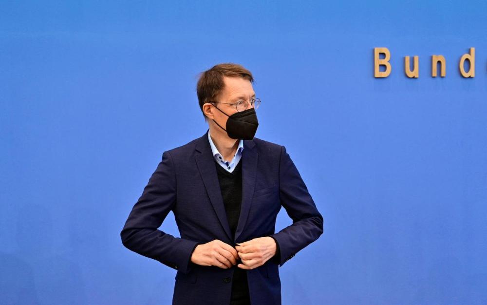 JOHN MACDOUGALL - AFP via GETTY IMAGES
German Health Minister Karl Lauterbach arrives at a March 25 press conference in Berlin. Germany is among a handful of countries seeing a dramatic increase in COVID-19 cases.