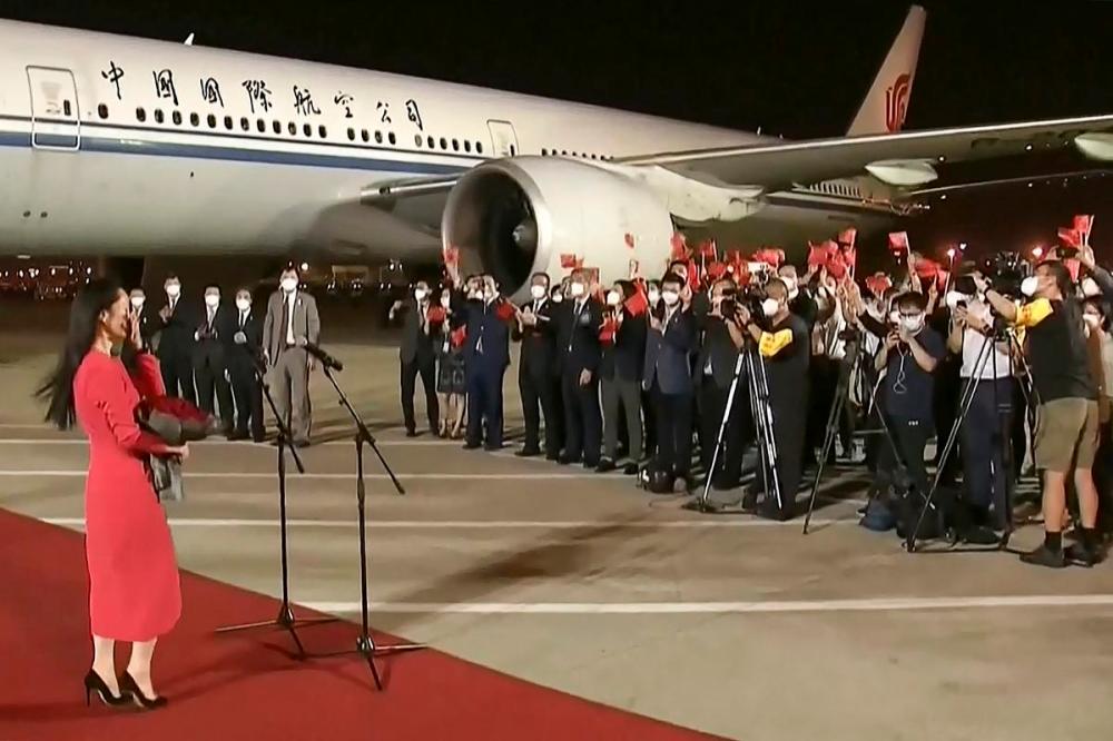 -/CCTV - TNS
Video released on Sept. 25, 2021 by Chinese state broadcaster CCTV shows people shouting and waving Chinese national flags at a Shenzhen airport after Huawei executive Meng Wanzhou returned from Canada.